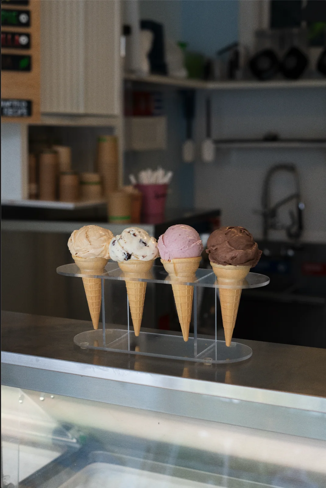 Four colorful ice cream cones at the Willard Scoops counter